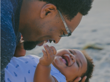 Man With Glasses Holding laughing Baby