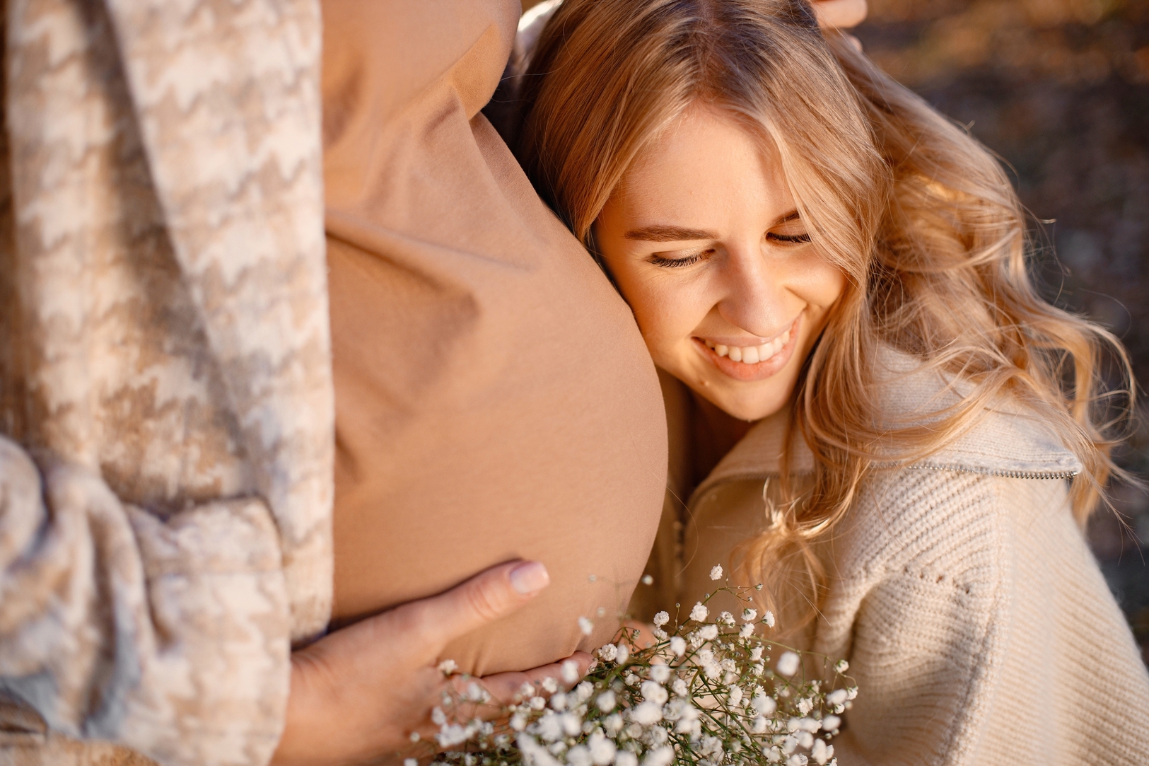 Portrait Of Curly Blonde Woman Near A Pregnant Belly